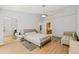Bright main bedroom with hardwood flooring, closet with mirrored doors, and a doorway to a bath at 3810 Darston St, Palm Harbor, FL 34685