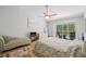Spacious main bedroom with a ceiling fan, TV, and sliding glass doors to a screened outdoor patio at 3810 Darston St, Palm Harbor, FL 34685