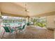 Covered patio with tables and chairs beside the pool perfect for relaxing outdoors at 3810 Darston St, Palm Harbor, FL 34685