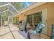 Enjoy outdoor living on this screened patio featuring comfortable seating and room for grilling at 3810 Darston St, Palm Harbor, FL 34685