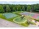 Aerial photo of a playground with slides and swing set surrounded by tennis and basketball courts at 3810 Darston St, Palm Harbor, FL 34685