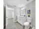 Bright bathroom features a dual sink vanity, modern fixtures, and a decorative piece of artwork above the toilet at 4508 26Th S Ave, Tampa, FL 33619