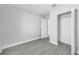 Bedroom with wood-look tile flooring, baseboard trim, and closet for storage at 4508 26Th S Ave, Tampa, FL 33619