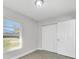 Bedroom with closet and light-colored walls and wood-look tile flooring at 4508 26Th S Ave, Tampa, FL 33619