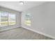 Bright bedroom featuring wood-style floors and large windows offering ample natural light at 4508 26Th S Ave, Tampa, FL 33619