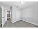 Neutral bedroom with wood-look floors, closet, and view to the bathroom at 4508 26Th S Ave, Tampa, FL 33619