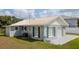 Charming home featuring a well-maintained lawn, white roof, and blue shutters enhancing its curb appeal at 4508 26Th S Ave, Tampa, FL 33619