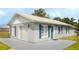 View of the exterior of the home, painted in neutral tones with contrasting blue shutters at 4508 26Th S Ave, Tampa, FL 33619