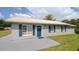 Charming single-story home featuring gray paint, blue shutters, and a light-colored metal roof at 4508 26Th S Ave, Tampa, FL 33619