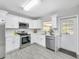 Modern kitchen with stainless steel appliances, white cabinets, and plenty of counter space at 4508 26Th S Ave, Tampa, FL 33619