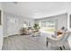 Bright living room with neutral tones, stylish furniture, and sliding glass doors to the outside at 4508 26Th S Ave, Tampa, FL 33619