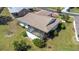 An aerial view of the home and back yard featuring mature landscaping and a screened in porch at 4534 Great Lakes S Dr, Clearwater, FL 33762