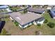 An aerial view shows the back of this home featuring mature landscaping and an enclosed porch at 4534 Great Lakes S Dr, Clearwater, FL 33762