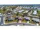 An aerial view of the home in a manicured community featuring mature landscaping and a community lake at 4534 Great Lakes S Dr, Clearwater, FL 33762