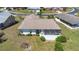 An aerial view displays the back of this home including a screened in porch and mature landscaping at 4534 Great Lakes S Dr, Clearwater, FL 33762