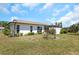 View of the spacious backyard, showcasing the home's exterior features and landscaping at 4534 Great Lakes S Dr, Clearwater, FL 33762