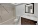 Bathroom featuring a shower-tub combo, matching toilet, and dark vanity with marble countertop at 4534 Great Lakes S Dr, Clearwater, FL 33762