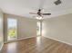 This bedroom has wood floors, a ceiling fan, and two windows for natural light at 4534 Great Lakes S Dr, Clearwater, FL 33762