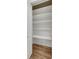 Storage closet with hardwood floors and bright white shelving and trim at 4534 Great Lakes S Dr, Clearwater, FL 33762