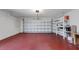 Spacious two car garage with painted floor and shelving for storage at 4534 Great Lakes S Dr, Clearwater, FL 33762