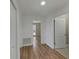 Hallway with hardwood floors and white doors leading to bedrooms and bathrooms at 4534 Great Lakes S Dr, Clearwater, FL 33762