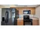 The updated kitchen features wood cabinets, stainless steel appliances, and plenty of natural light at 4534 Great Lakes S Dr, Clearwater, FL 33762