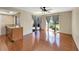 Living room features hardwood floors, ceiling fan, and sliding glass door which provides natural light at 4534 Great Lakes S Dr, Clearwater, FL 33762