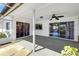 This covered patio offers a ceiling fan, decorative rock, and natural light at 4534 Great Lakes S Dr, Clearwater, FL 33762