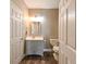 Modern bathroom featuring a single sink vanity, wood-look flooring, and a separate toilet room at 5000 Culbreath Key Way # 9-104, Tampa, FL 33611
