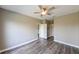 Light and bright bedroom with wood floors, ceiling fan, and doors leading to closets and other rooms at 5000 Culbreath Key Way # 9-104, Tampa, FL 33611