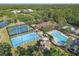 Overhead view of resort-style community amenities including tennis courts and a sparkling pool at 5634 Tanagergrove Way, Lithia, FL 33547