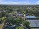 Aerial view showcasing community pool, tennis, and basketball courts amidst lush greenery at 5634 Tanagergrove Way, Lithia, FL 33547