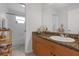 Bright bathroom with a tiled shower, bathtub, and a granite countertop sink at 5634 Tanagergrove Way, Lithia, FL 33547