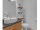 Stylish bathroom featuring a modern sink, open shelves, and neutral wall paint at 5634 Tanagergrove Way, Lithia, FL 33547
