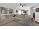 Comfortable living room with hardwood floors and archway to the kitchen and dining area at 5634 Tanagergrove Way, Lithia, FL 33547