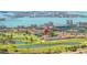 Expansive aerial view showcasing the golf course, waterfront, residential buildings, and the surrounding city at 6131 Bahia Del Mar Blvd # 240, St Petersburg, FL 33715