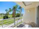 Cozy balcony seating area with golf course views, surrounded by swaying palm trees and manicured landscaping at 6131 Bahia Del Mar Blvd # 240, St Petersburg, FL 33715