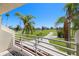 Expansive golf course view from balcony, showcasing lush greenery and mature palm trees against a clear sky at 6131 Bahia Del Mar Blvd # 240, St Petersburg, FL 33715