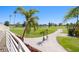 Picturesque view from balcony, showcasing a lush golf course landscape with mature trees and clear blue skies at 6131 Bahia Del Mar Blvd # 240, St Petersburg, FL 33715