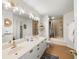 Bright bathroom featuring dual sinks, modern lighting, and walk-in shower and tub combo at 6131 Bahia Del Mar Blvd # 240, St Petersburg, FL 33715