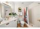 Bright bathroom featuring sink, modern fixtures, vanity, and walk-in shower with patterned curtain at 6131 Bahia Del Mar Blvd # 240, St Petersburg, FL 33715