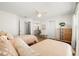 Guest bedroom showcasing twin beds with ceiling fan and easy access to walk in closet and ensuite at 6131 Bahia Del Mar Blvd # 240, St Petersburg, FL 33715