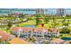 Exterior shot of building featuring lush landscaping and a view of the nearby golf course and water at 6131 Bahia Del Mar Blvd # 240, St Petersburg, FL 33715