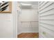 Walk-in closet featuring adjustable shelving, wooden floor, and bright natural lighting at 6131 Bahia Del Mar Blvd # 240, St Petersburg, FL 33715