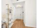 Bright entryway with white walls, wood floors, decorative shelving and modern light fixture at 6131 Bahia Del Mar Blvd # 240, St Petersburg, FL 33715