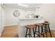 Kitchen bar with wood stools and a large clock at 6131 Bahia Del Mar Blvd # 240, St Petersburg, FL 33715