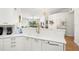 Bright kitchen with white cabinets, quartz countertops, and updated appliances, open to the living spaces at 6131 Bahia Del Mar Blvd # 240, St Petersburg, FL 33715