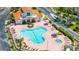 Aerial view of a community pool and hot tub, surrounded by lounge chairs and manicured landscaping at 6131 Bahia Del Mar Blvd # 240, St Petersburg, FL 33715