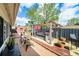 Enclosed backyard featuring a modern hot tub with a pergola, beautiful potted plants, and seating at 6821 Tierra Verde St, Port Richey, FL 34668