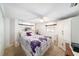 Charming bedroom with a floral-patterned bedding, white ceiling fan and window blinds at 6821 Tierra Verde St, Port Richey, FL 34668
